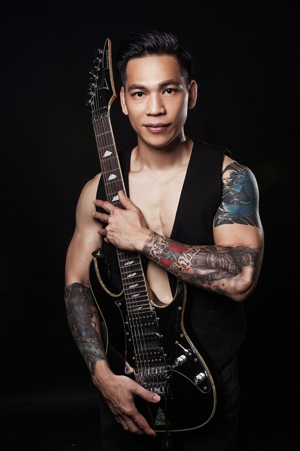 Haipeng Lan holding an electric guitar